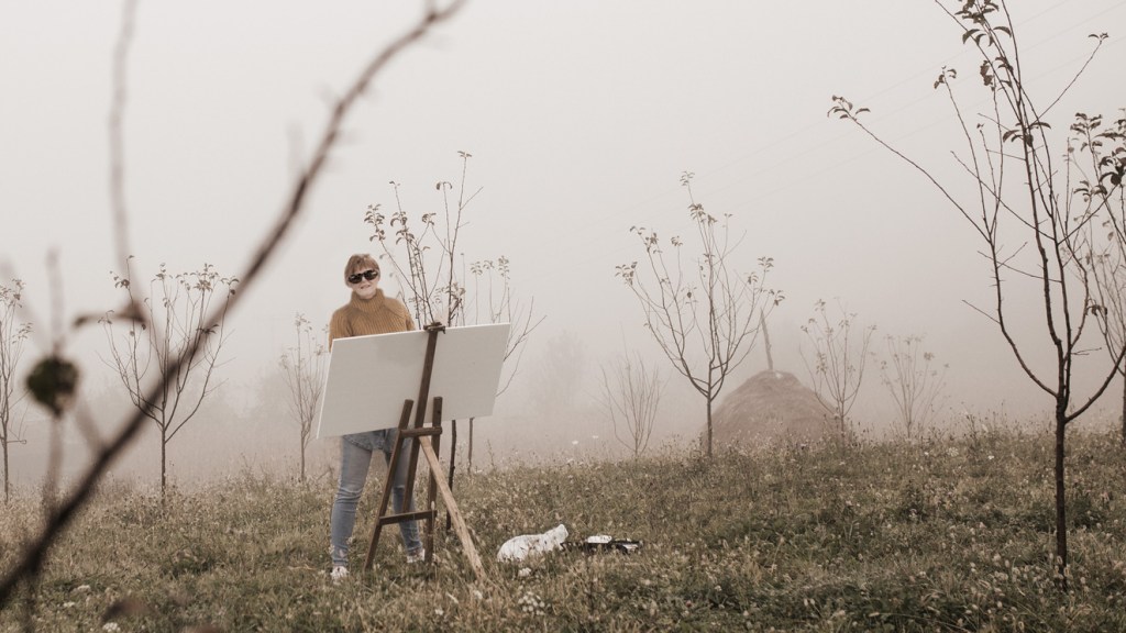 Sangdrol Dawn Blanchard painting in a misty field in Colorado